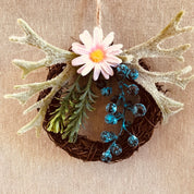 Mini floral wreath ornament with artificial flowers, ideal as a fairy door accessory or mini decor.