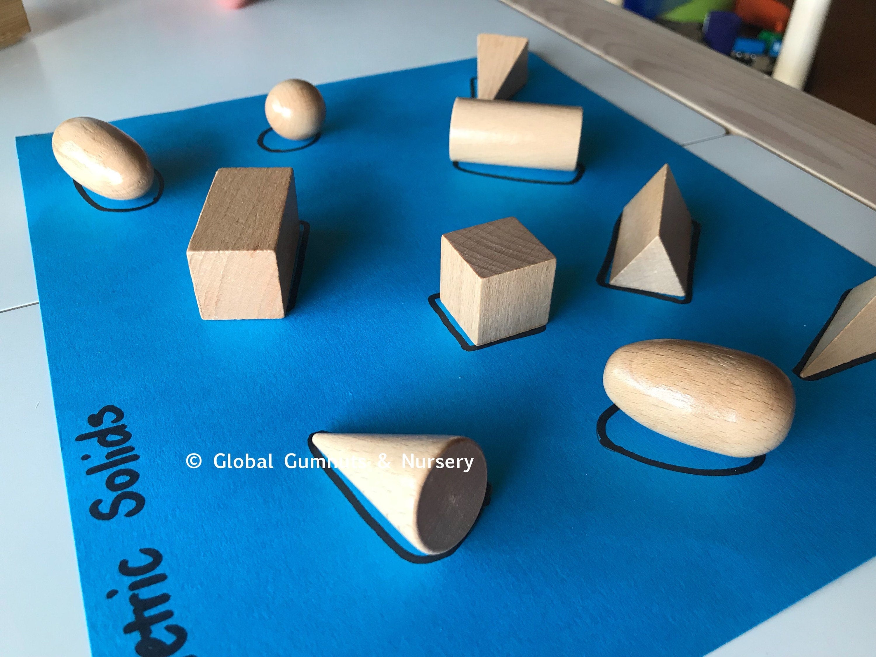 Set of 10 geometric wooden 3D solids, ideal for teaching shapes, math, or STEM learning.