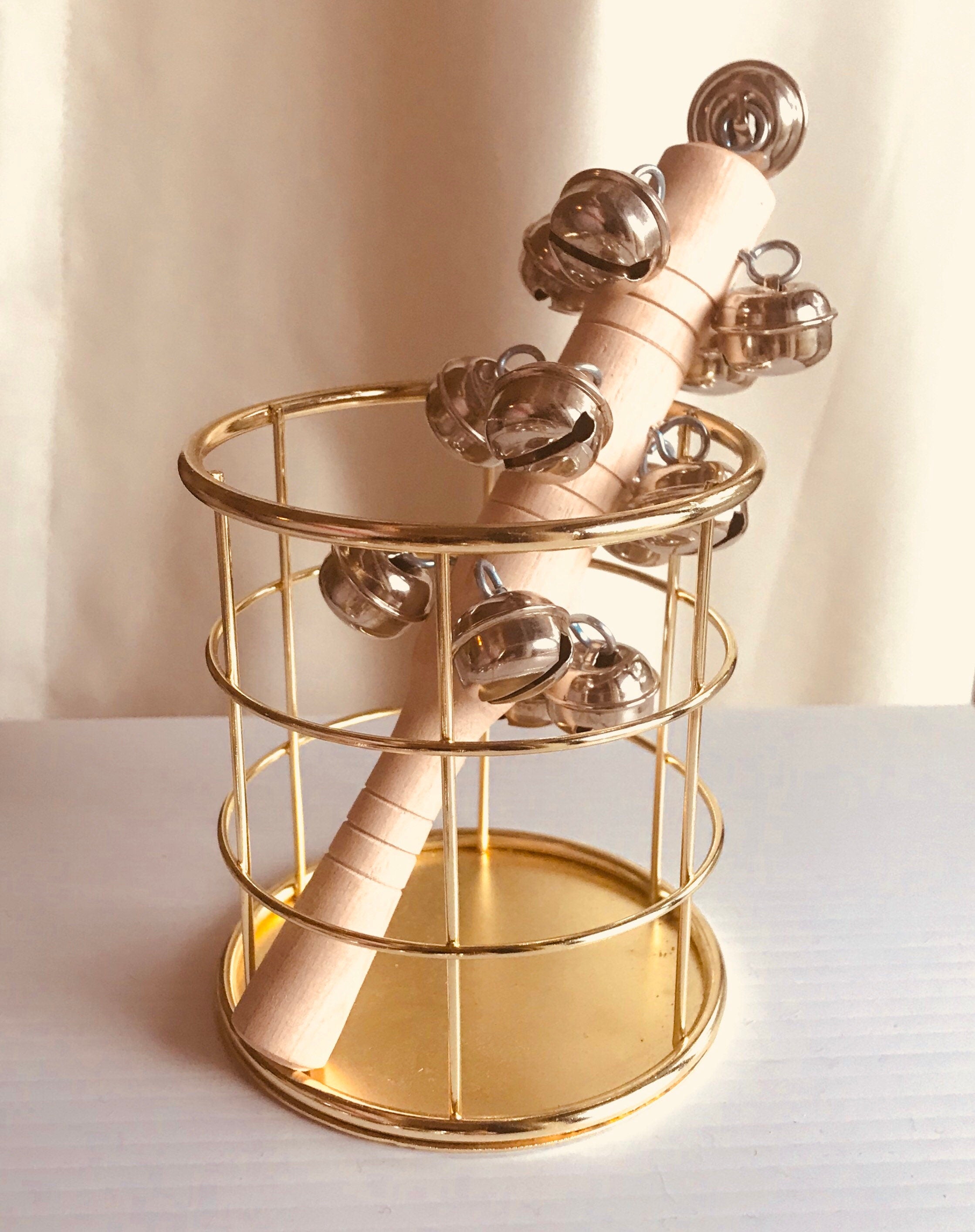 Jasmine bell rattle, a soft-sounding handmade rattle perfect for sensory play.