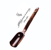 Long-handled wooden scoop, a versatile spoon perfect for natural play or kitchen use.