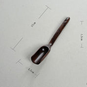 Long-handled wooden scoop, a versatile spoon perfect for natural play or kitchen use.