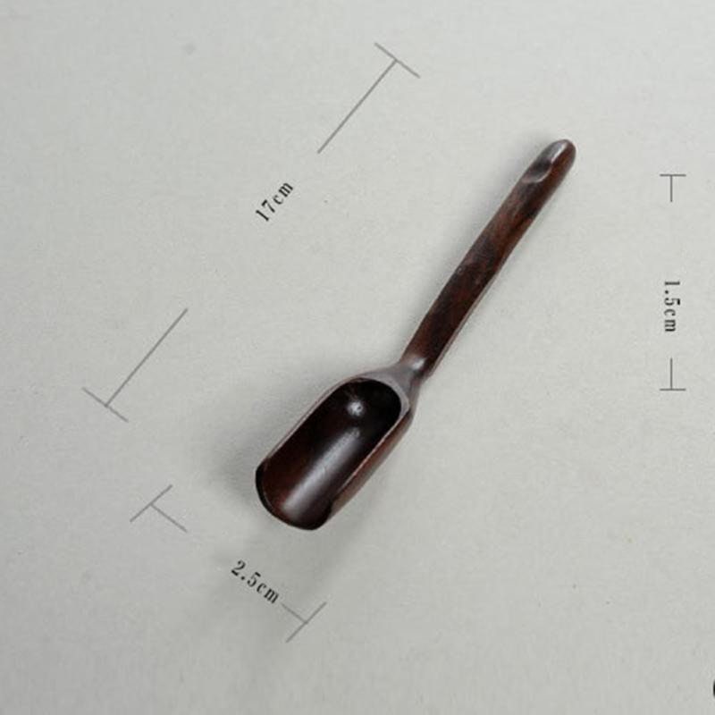 Long-handled wooden scoop, a versatile spoon perfect for natural play or kitchen use.
