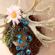 Mini floral wreath ornament with artificial flowers, ideal as a fairy door accessory or mini decor.