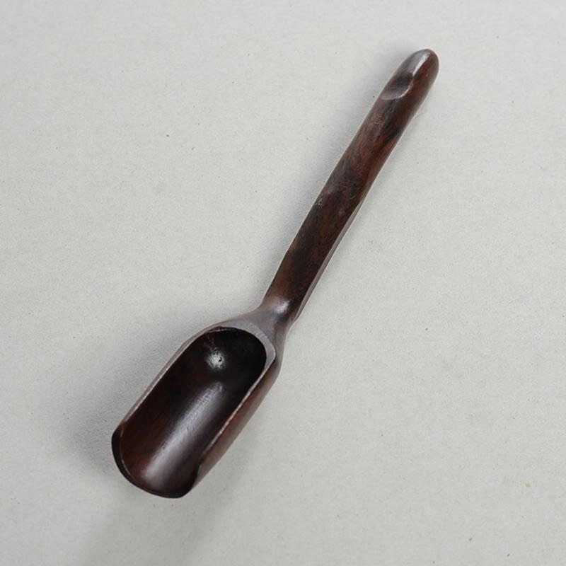 Long-handled wooden scoop, a versatile spoon perfect for natural play or kitchen use.