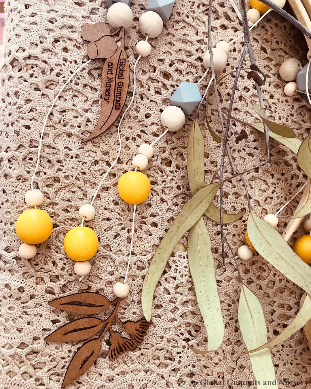Australian Gumnut Arched Mobile: Delicate gumnut mobile for nursery decor.