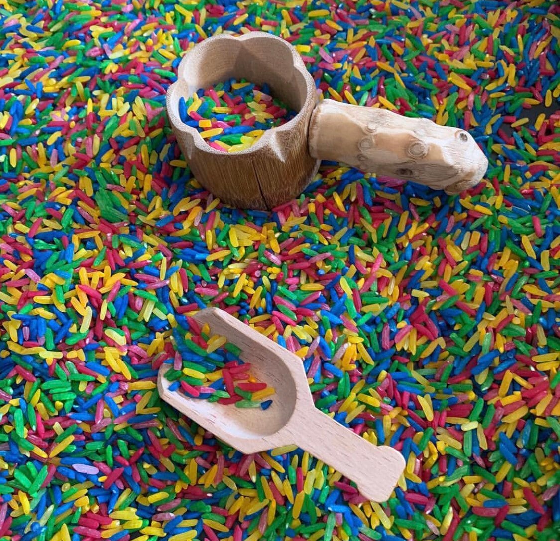Water play scoop with holes in a bucket, perfect for sensory or outdoor play.