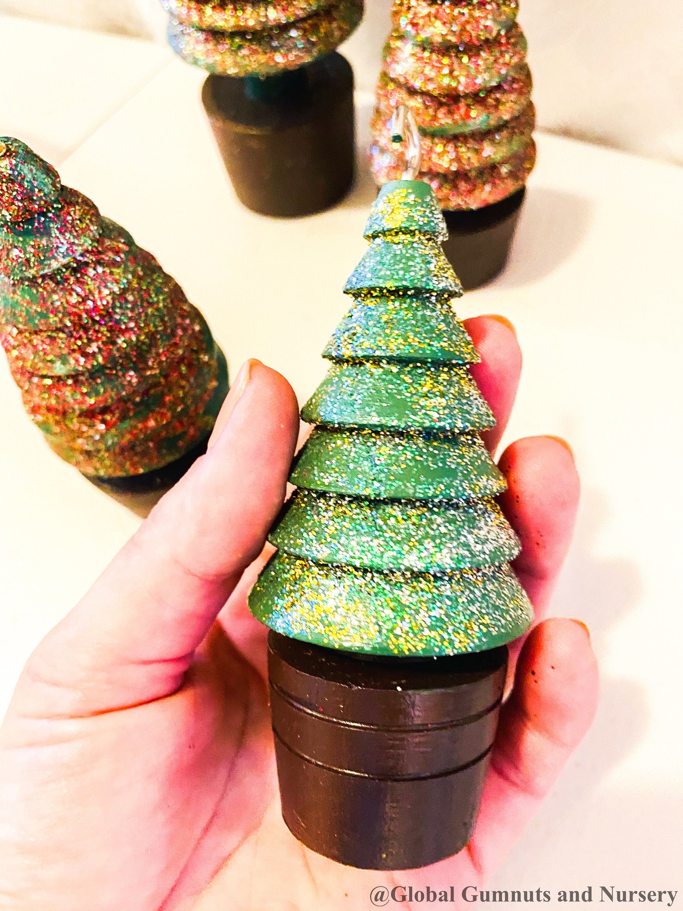 Glittery handmade wooden Christmas trees, creating a magical forest decor for the holiday season.