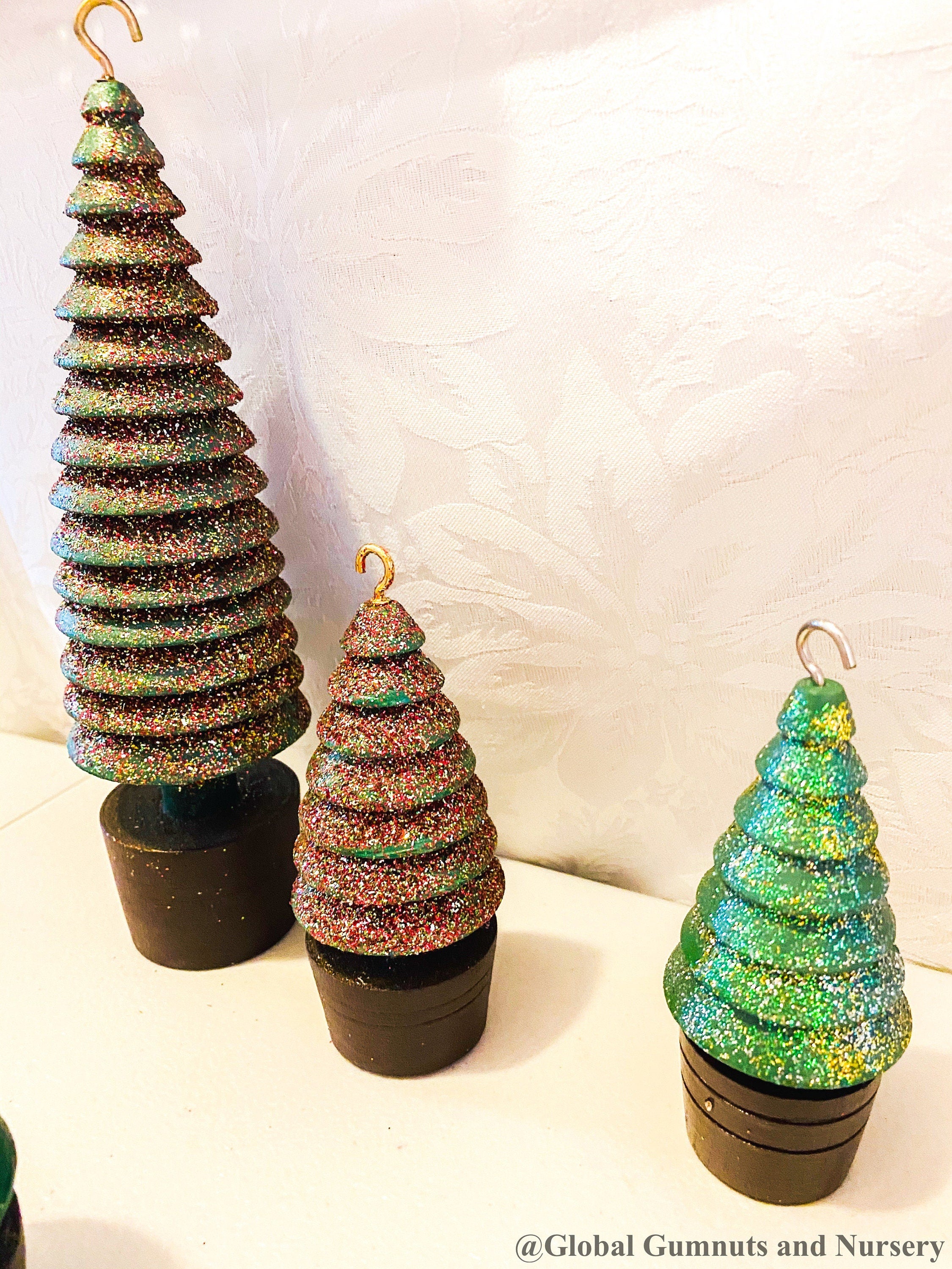 Glittery handmade wooden Christmas trees, creating a magical forest decor for the holiday season.