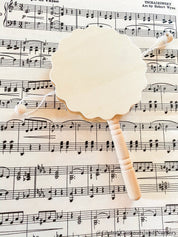 Natural wooden rattle drum, an engaging and eco-friendly musical toy for babies.