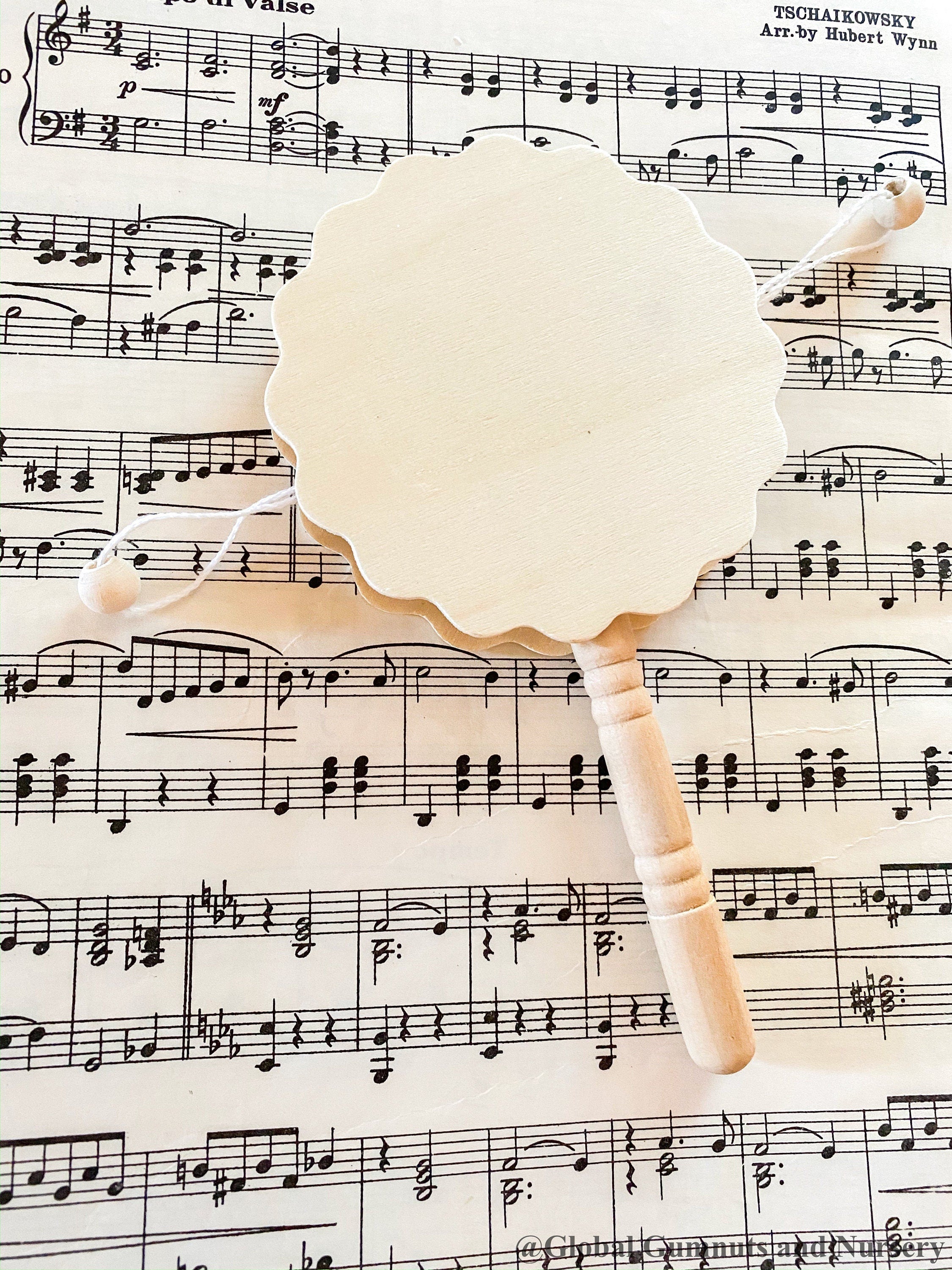 Natural wooden rattle drum, an engaging and eco-friendly musical toy for babies.