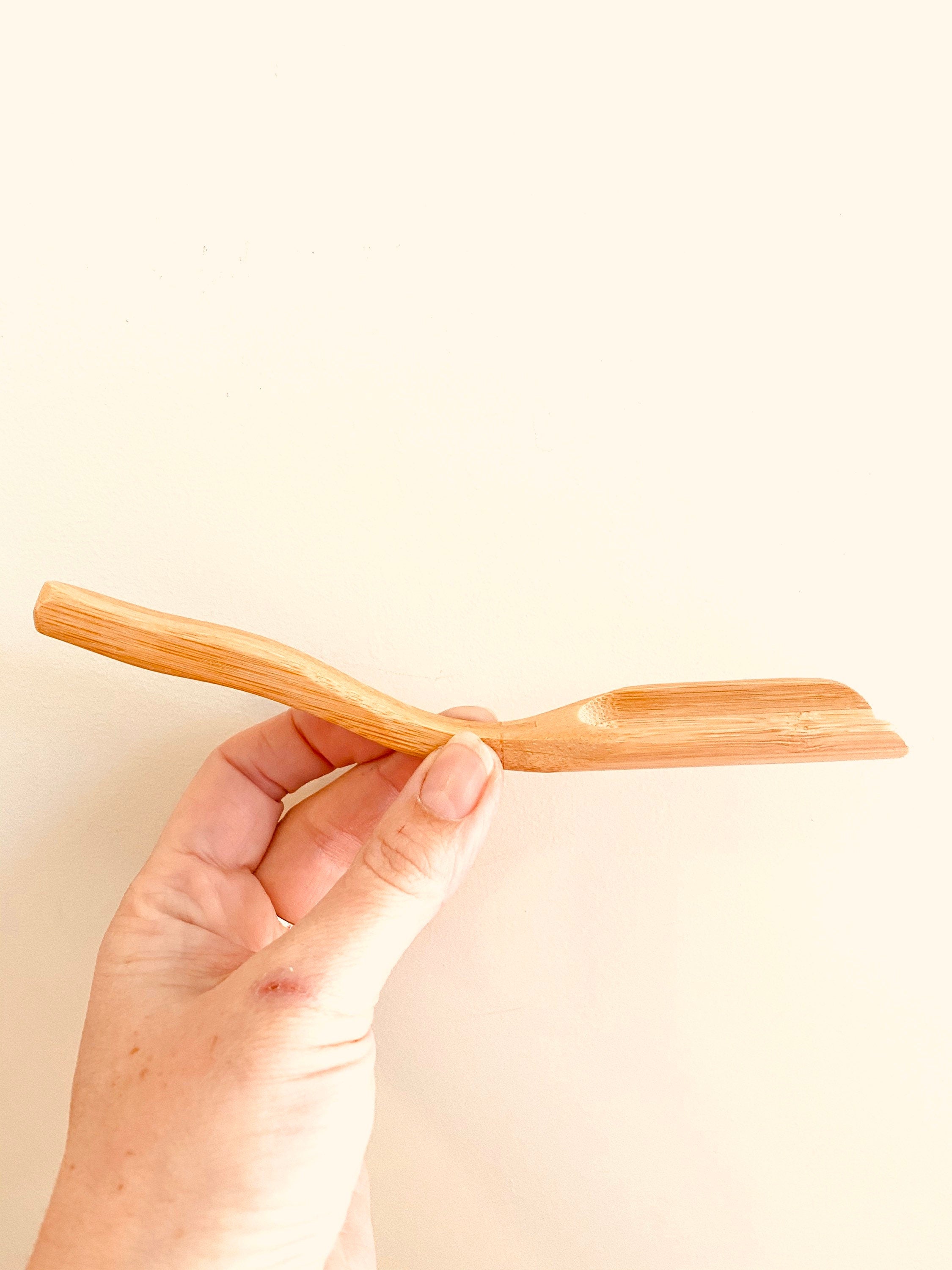 Long-handled wooden scoop, a versatile spoon perfect for natural play or kitchen use.