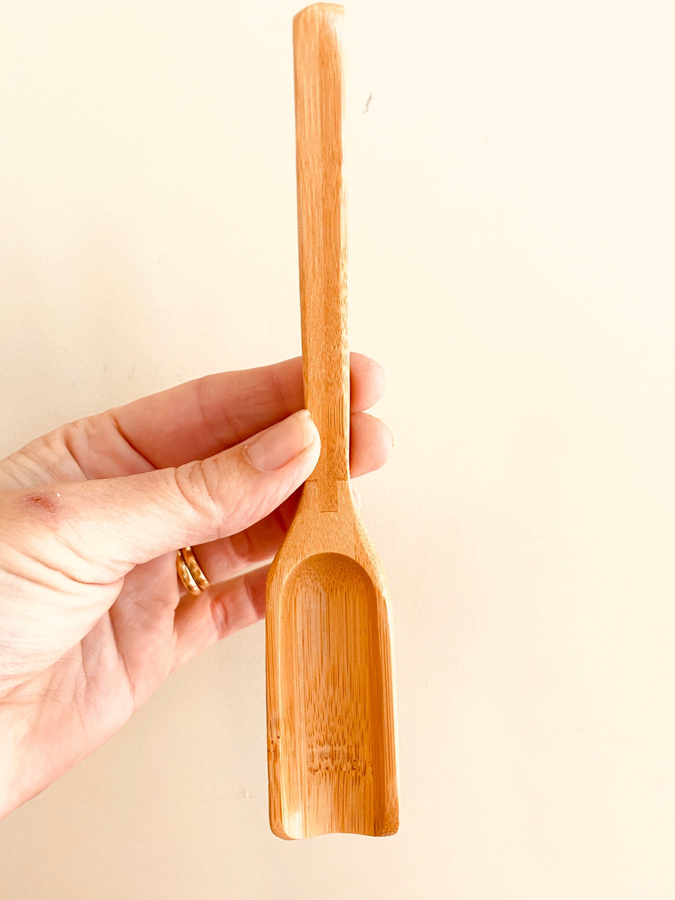 Long-handled wooden scoop, a versatile spoon perfect for natural play or kitchen use.