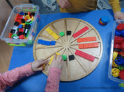 Wooden sorting board with 12 colorful sections for educational activities like counting, color sorting, and clock learning.