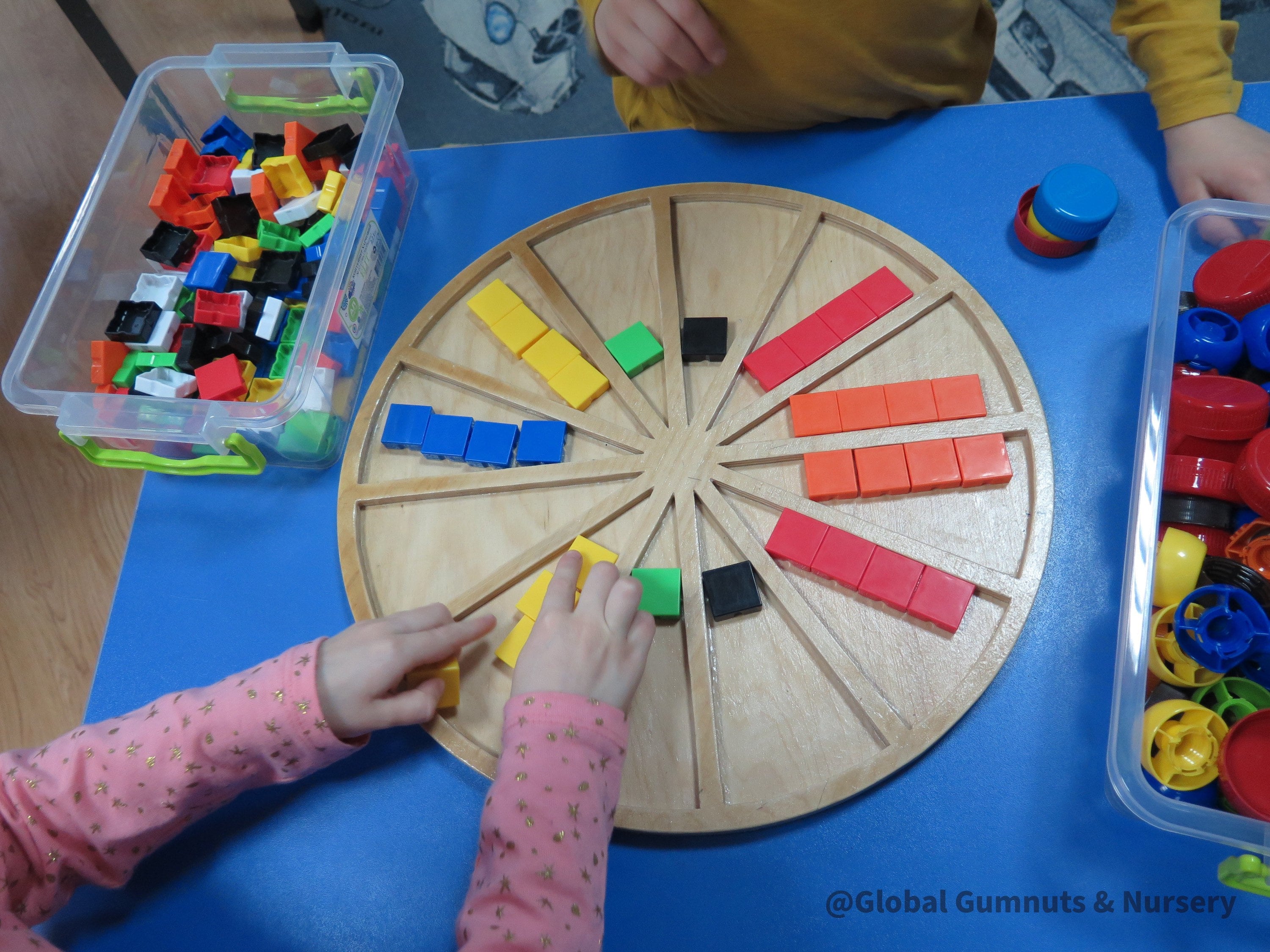 Wooden sorting board with 12 colorful sections for educational activities like counting, color sorting, and clock learning.