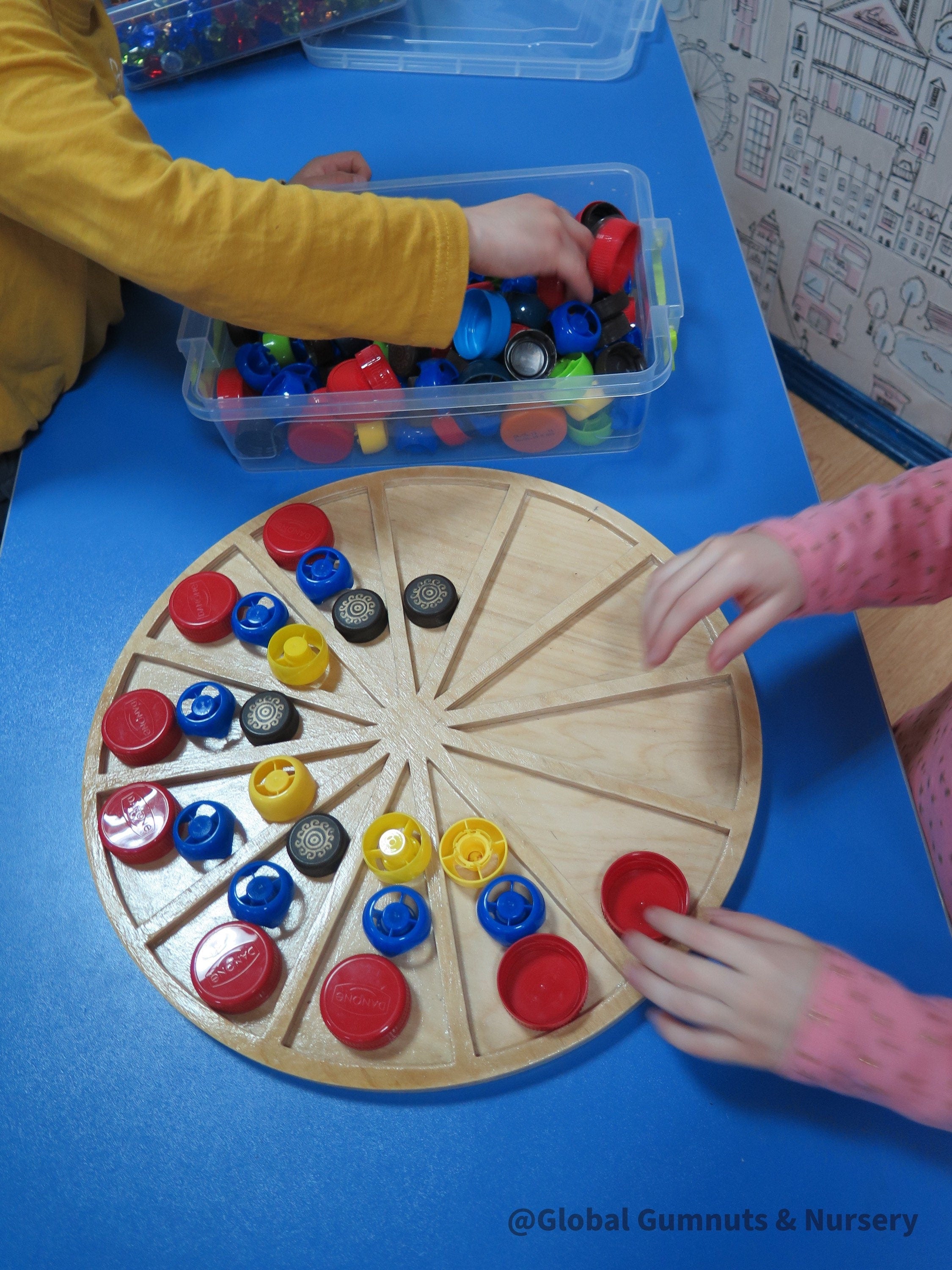 Wooden sorting board with 12 colorful sections for educational activities like counting, color sorting, and clock learning.