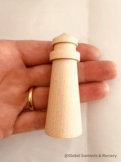 Mini wooden lighthouse, a charming addition to beach-themed decor or playtime.