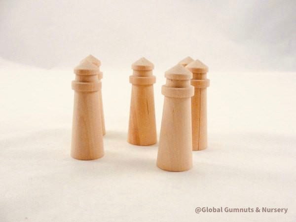 Mini wooden lighthouse, a charming addition to beach-themed decor or playtime.