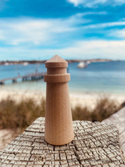 Mini wooden lighthouse, a charming addition to beach-themed decor or playtime.