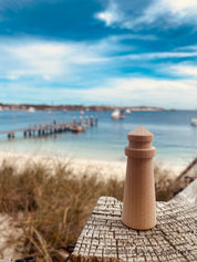 Mini wooden lighthouse, a charming addition to beach-themed decor or playtime.