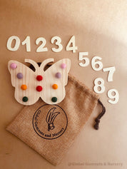 Rainbow Butterfly Tens Board: Educational counting board with felt balls and numbers.
