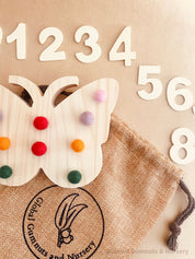 Rainbow Butterfly Tens Board: Educational counting board with felt balls and numbers.