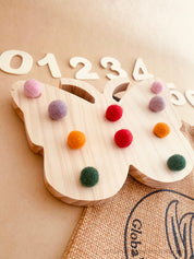 Rainbow Butterfly Tens Board: Educational counting board with felt balls and numbers.