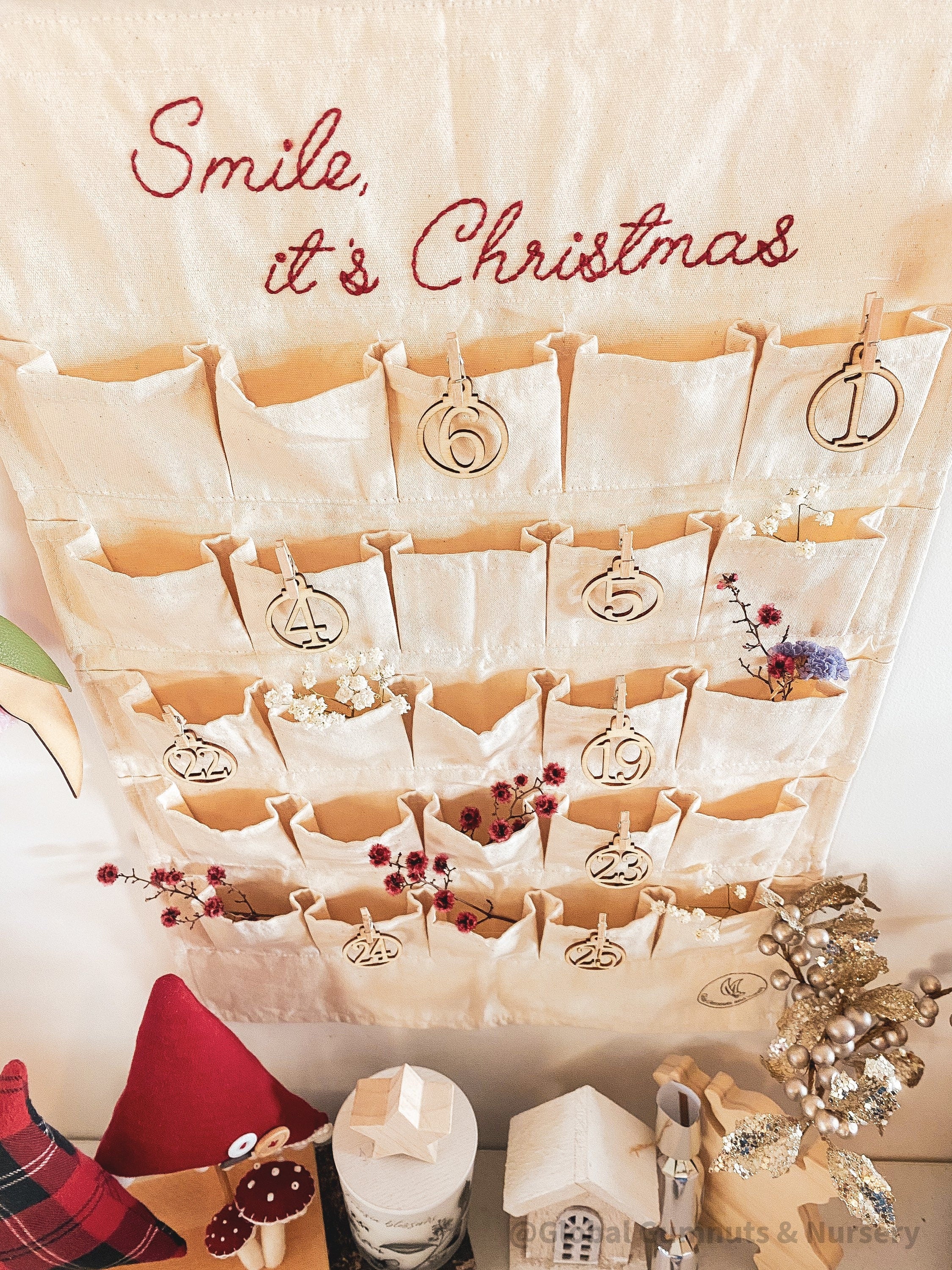 Linen Advent Calendar: Advent calendar with wooden numbers and festive design.