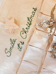 Linen Advent Calendar: Advent calendar with wooden numbers and festive design.