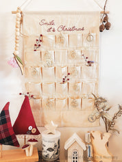 Linen Advent Calendar: Advent calendar with wooden numbers and festive design.