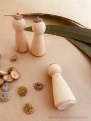 Eucalyptus Caps: Wooden doll caps made from eucalyptus seeds for sensory play.
