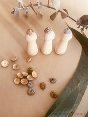 Eucalyptus Caps: Wooden doll caps made from eucalyptus seeds for sensory play.