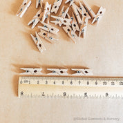 Mini wooden pegs, versatile clips ideal for advent calendars or craft projects.