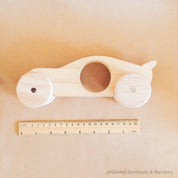 Race Car with Spoiler: Handmade wooden race car with push-pull functionality.