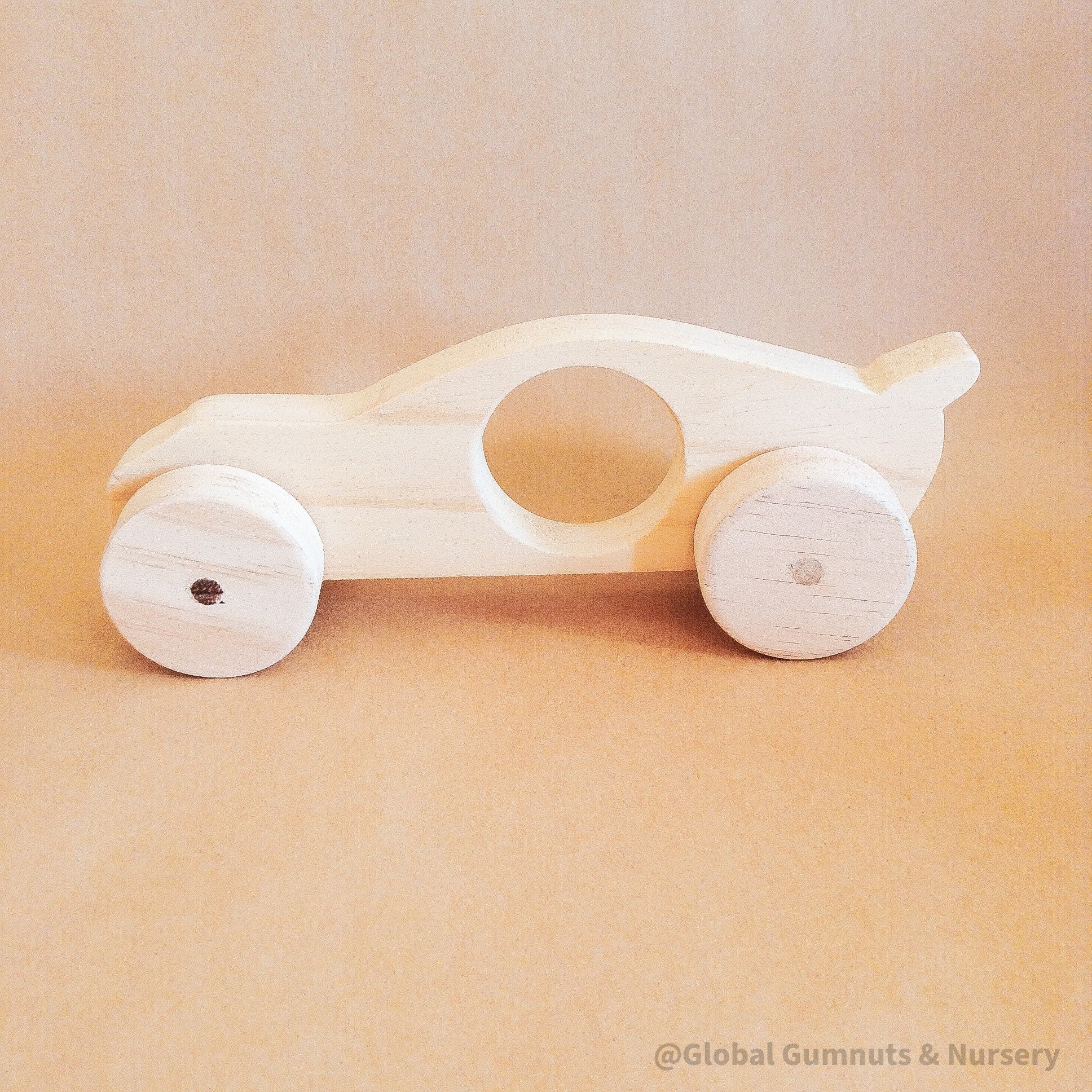 Race Car with Spoiler: Handmade wooden race car with push-pull functionality.