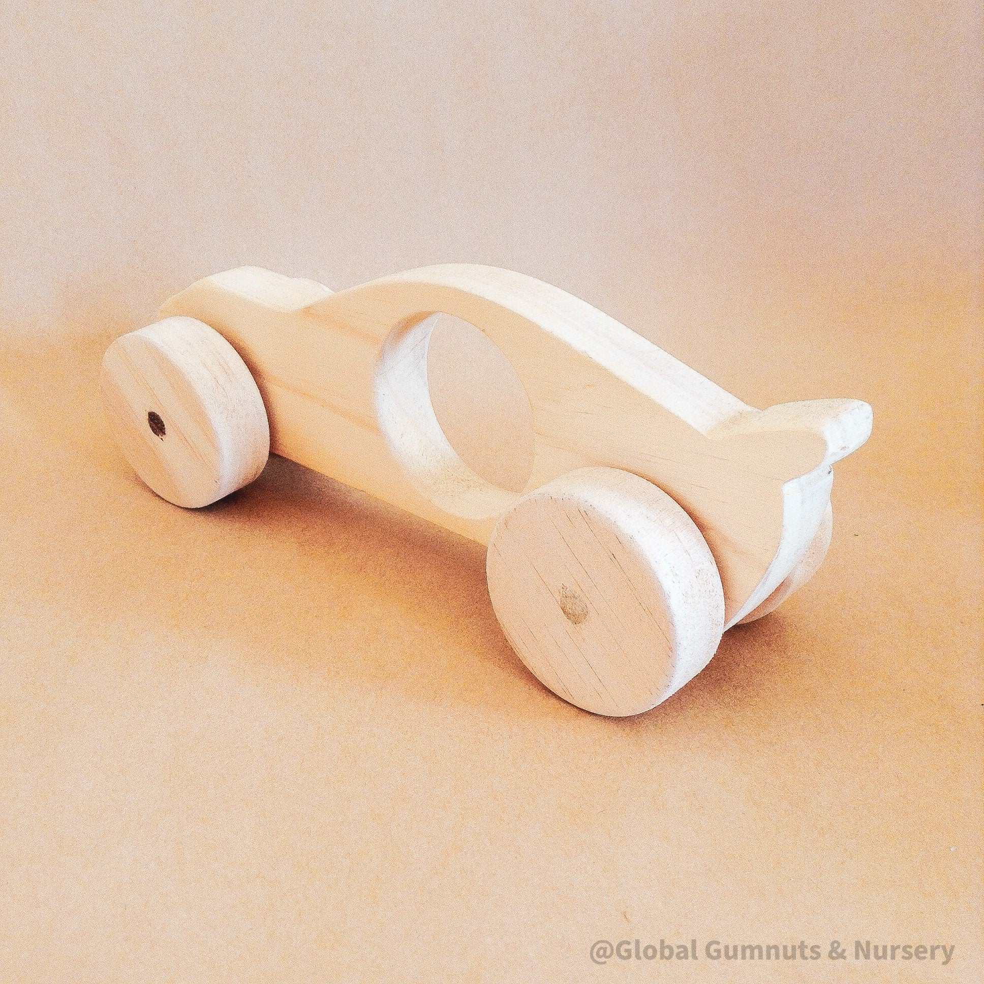 Race Car with Spoiler: Handmade wooden race car with push-pull functionality.