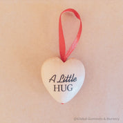 Gift a wooden heart engraved with love, a pocket-sized token of affection perfect for sending "a little hug."