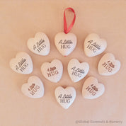 Gift a wooden heart engraved with love, a pocket-sized token of affection perfect for sending "a little hug."