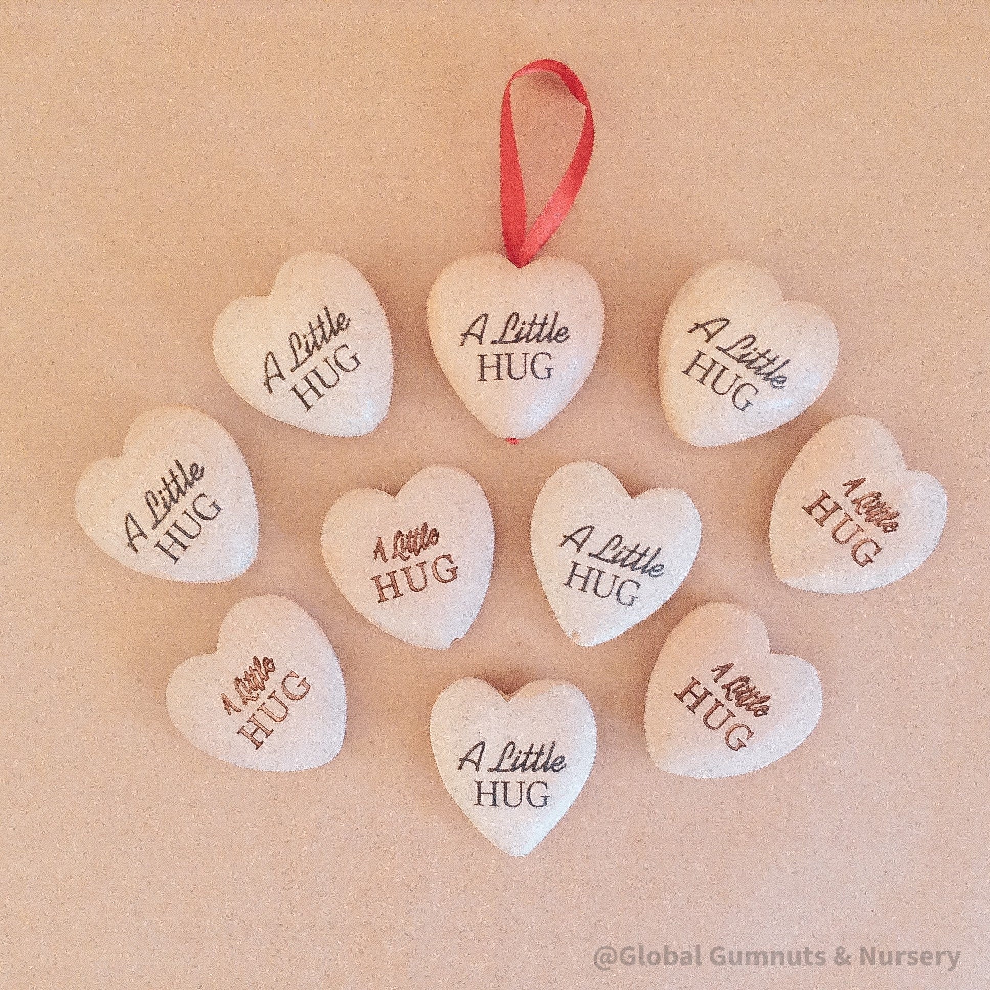 Gift a wooden heart engraved with love, a pocket-sized token of affection perfect for sending "a little hug."