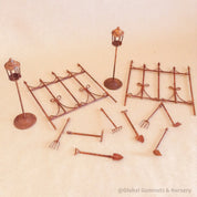 Miniature fairy garden accessories set with fencing, tools, and lamp posts for magical play.