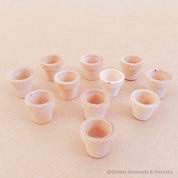 Miniature wooden flower pots for dollhouses and crafts. Ideal for creating tiny gardens or adding charm to DIY projects.