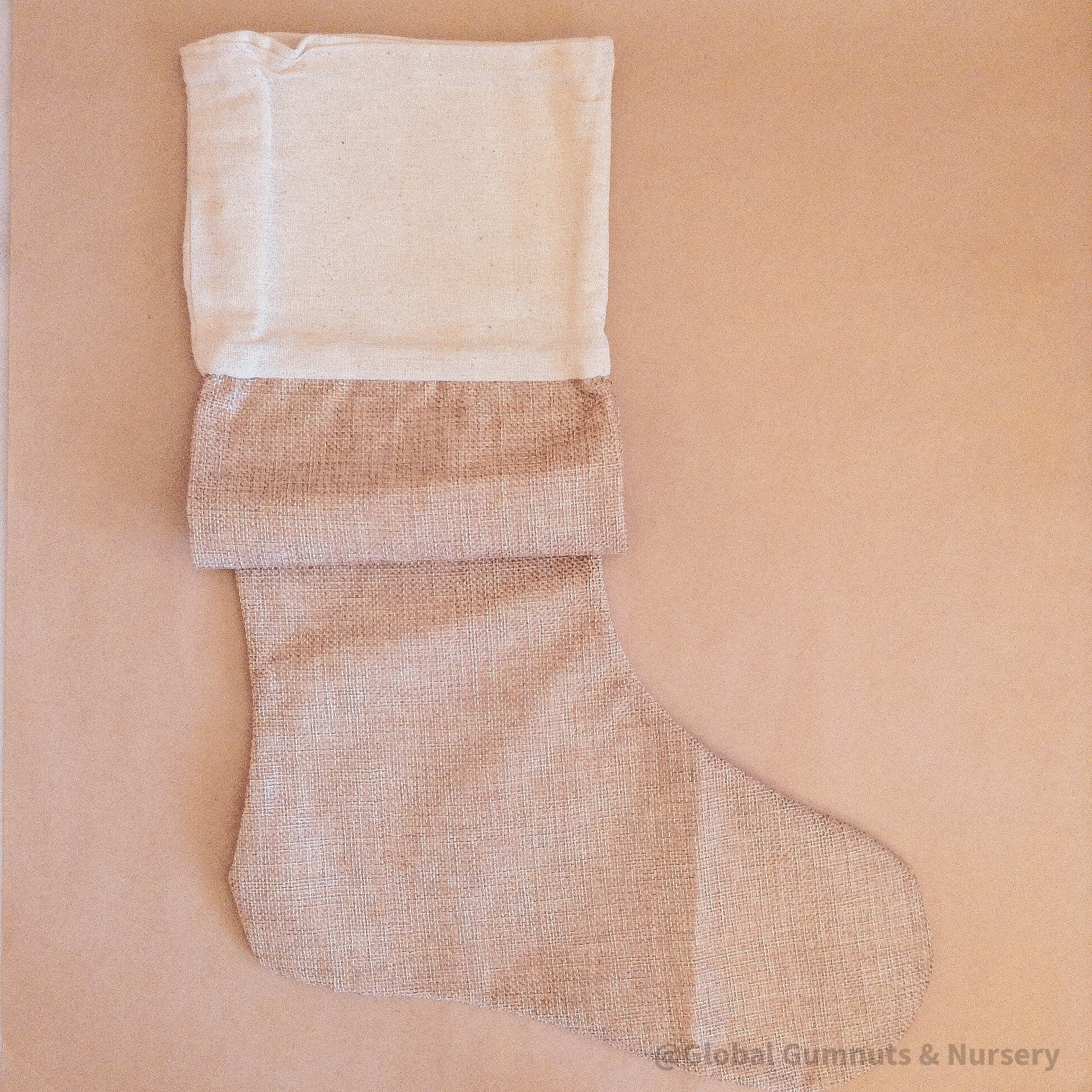 Personalized farmhouse Christmas stocking in jute linen, a rustic holiday charm.