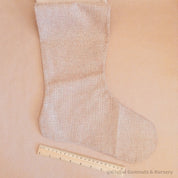 Personalized farmhouse Christmas stocking in jute linen, a rustic holiday charm.
