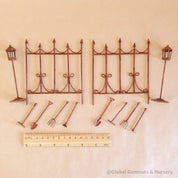 Miniature fairy garden accessories set with fencing, tools, and lamp posts for magical play.