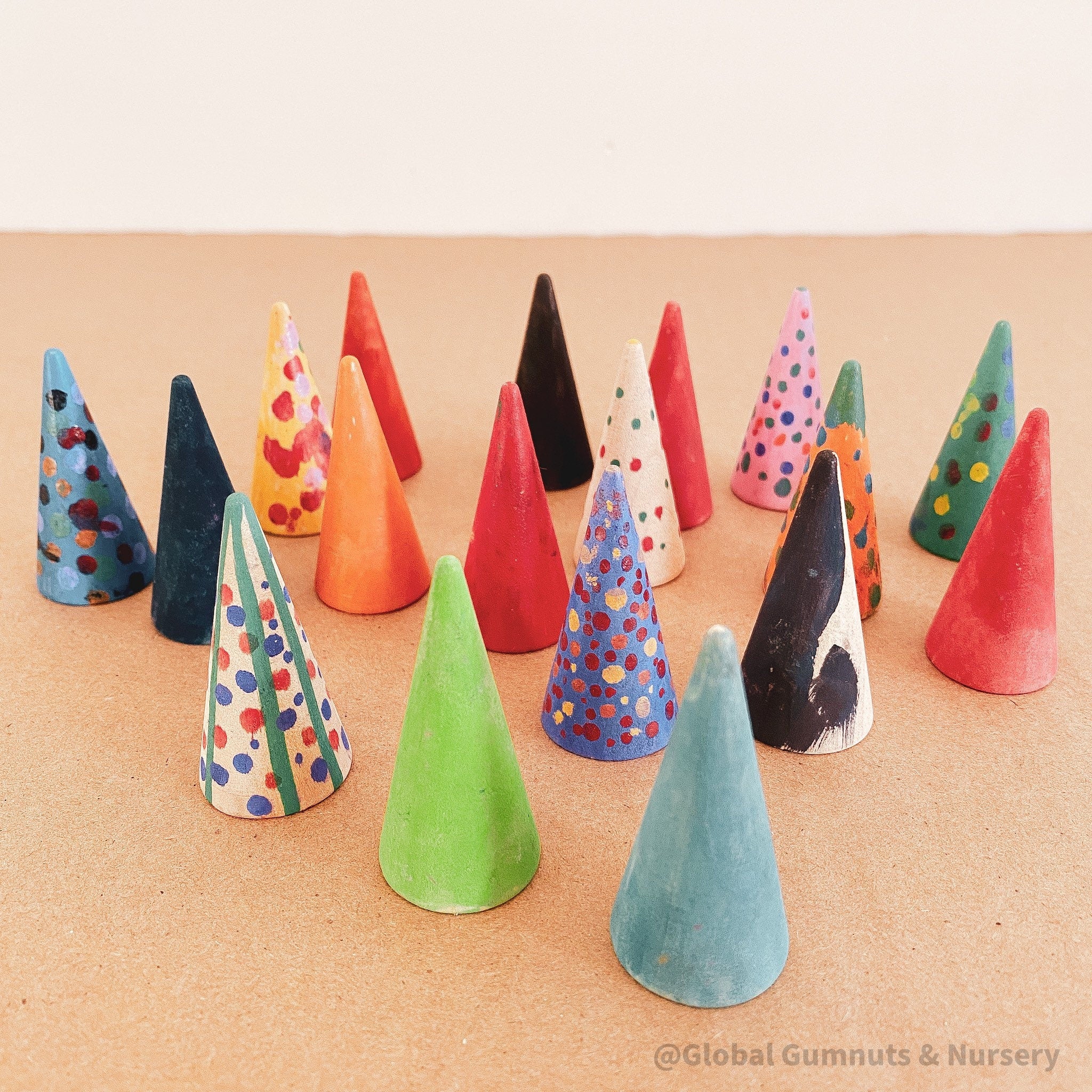 Mini wooden forest set, featuring hand-painted Christmas trees created by children.