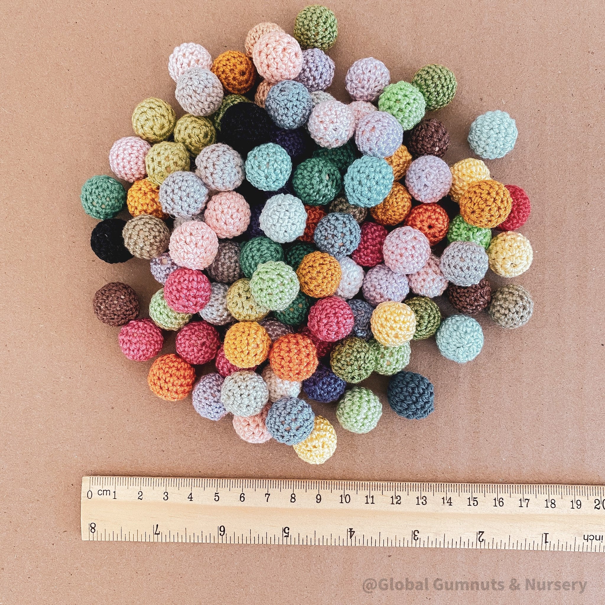 Crochet beaded wooden balls in warm or cool tones, perfect for sensory play, jewelry-making, or decor.