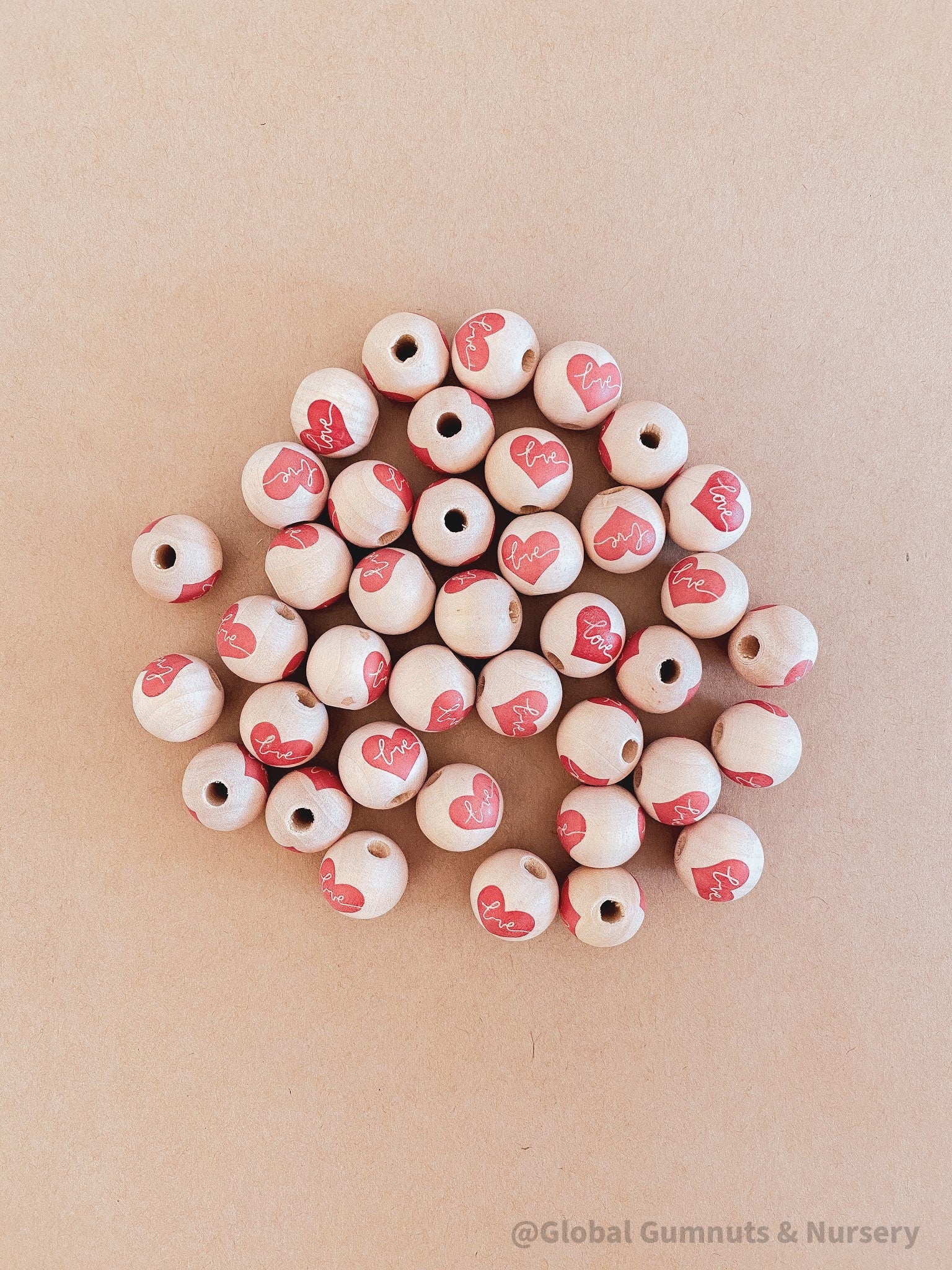 wooden love red heart beads: beautiful wooden beads with drilled holes in the shape of red hearts, perfect for diy craft projects and jewellery.