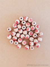 wooden love red heart beads: beautiful wooden beads with drilled holes in the shape of red hearts, perfect for diy craft projects and jewellery.