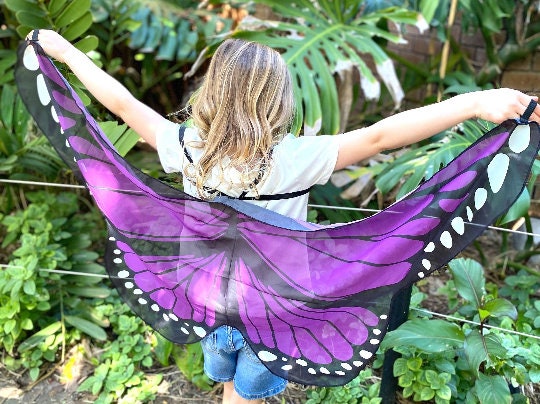 Vibrant butterfly wings for kids, custom chiffon designs with glitter and sparkle, perfect for dress-up or dance.