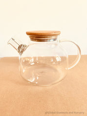 Glass Teapot with Bamboo Lid: Stylish glass teapot with bamboo lid, perfect for tea time or as a display piece for modern decor.