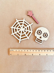 Halloween Embellishments Set: Halloween-themed wooden decorations including spiders and skulls.